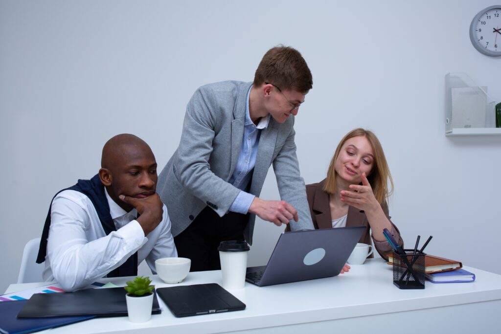 A Man in deep thought sitting next to his team